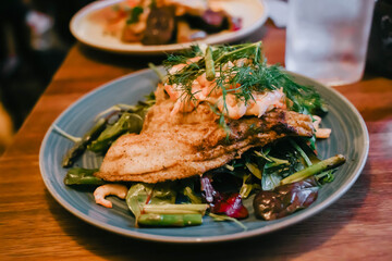 Chicken and shrimps are grilled with vegetables on dish, Danish food.