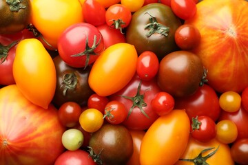 Different ripe juicy tomatoes as background, closeup