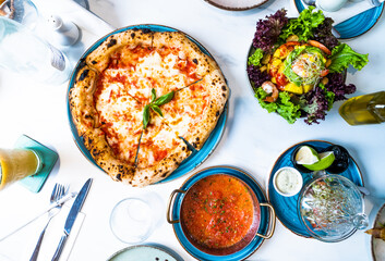 Pizza with salad and  juice on marble table Morocco September 3, 2025