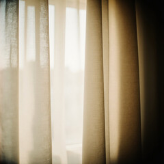 Soft morning light shines through beige curtains, casting gentle shadows in a cozy space. The atmosphere feels calm and inviting, perfect for relaxation Generative AI