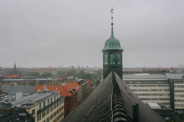 View of Trinitatis Kirke from the Round Tower in Copenhagen city, Denmark on rainy day.