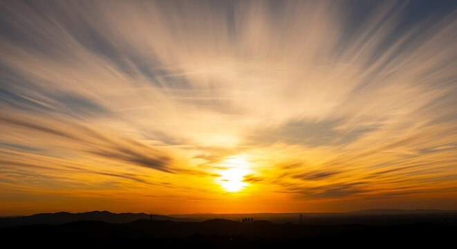 A breathtaking sunset sky ablaze with golden hues, featuring a dramatic cloud formation.