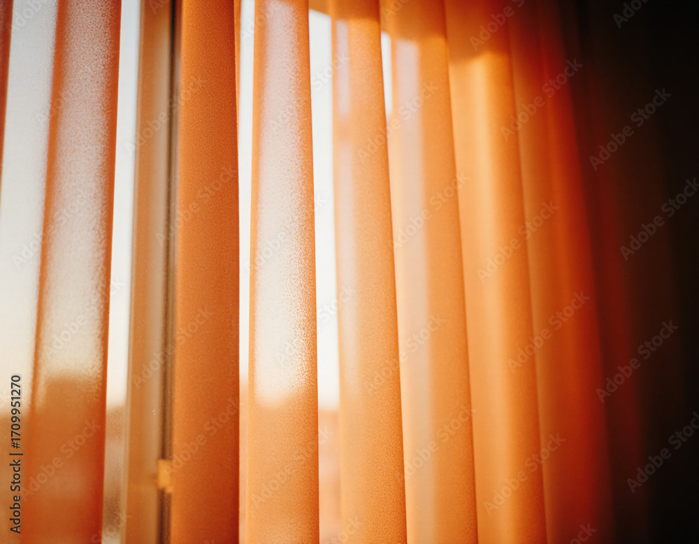 Poster soft sunlight streams through delicate red curtains, creating a cozy atmosphere in the room as eveni
