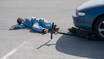 A Caucasian woman on a scooter after being hit by a car.