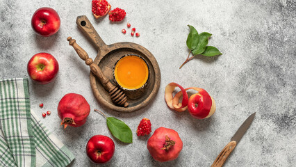 Honey, apples and pomegranate on a light rustic background. Jewish New Year, Rosh Hashanah. Top view, flat lay
