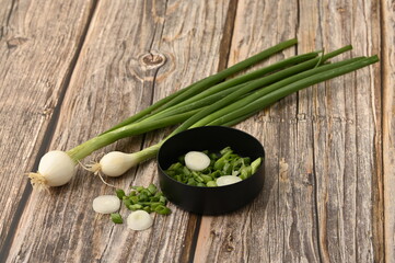 Fresh  onion an wooden table.  White and green vegetable.