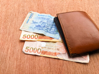 Wallet and banknotes in one thousand and five thousand yen denominations