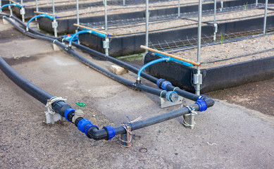 Close-up of an agricultural water management infrastructure system with pipes and valves. Modern agriculture. Maintenance of agricultural irrigation systems.