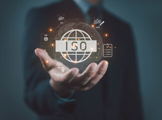 ISO certification concept with businessman holding digital globe and compliance icons, representing quality assurance, international standards, audit, business trust, and certified management system.
