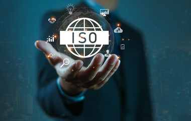 Businessman holding ISO certification icon with global network, representing international standards, quality assurance, compliance, management system, business excellence, and corporate governance.