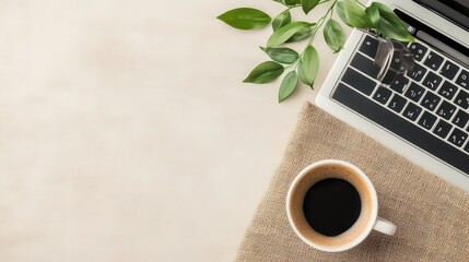 A stylish workspace featuring a laptop, a cup of coffee, and greenery, perfect for promoting productivity, remote work, or relaxation themes in marketing materials and design projects,