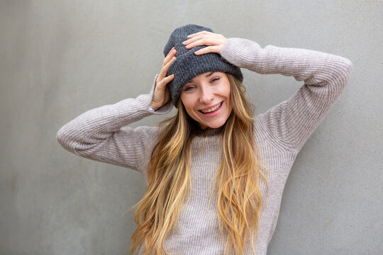 Portrait female in beanie with hands on head