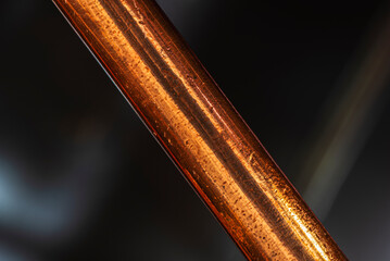 Copper rod with texture in close-up in an industrial space