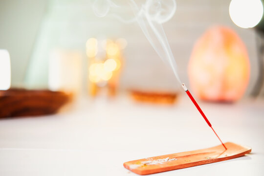 Burning scented stick burning on table - Powered by Adobe