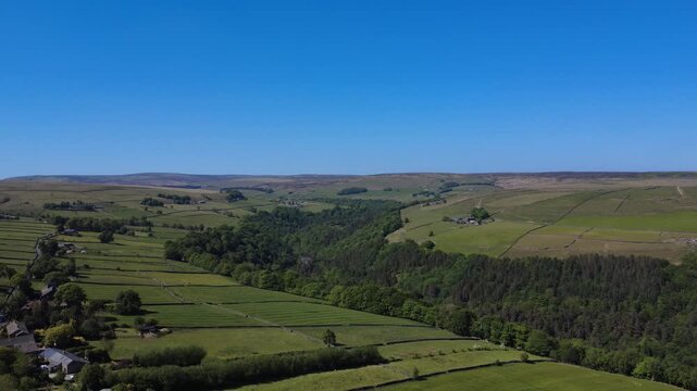 view of calderdale countryside with the village of slack next to hardcastle crags woodland near hebden bridge in summer