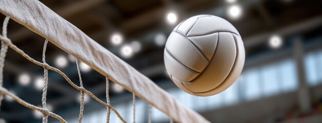 Volleyball soaring over the net in an indoor arena during a competitive match, showcasing the energy and excitement of the game