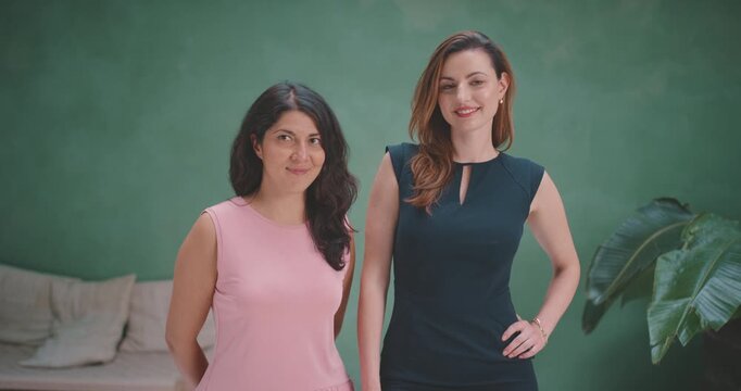 Two beautiful models posing in green screen studio