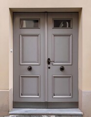 Classic light gray double doors with decorative panels