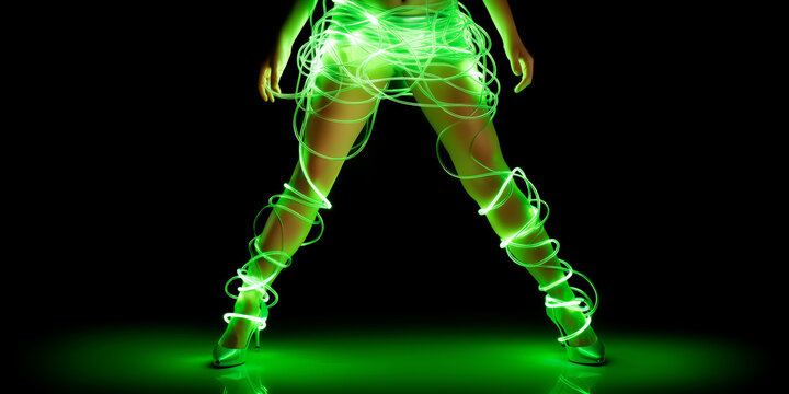 Female legs wrapped in glowing green neon wires