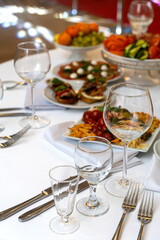 A beautifully arranged plate of assorted bruschetta, canapes, and marinated appetizers