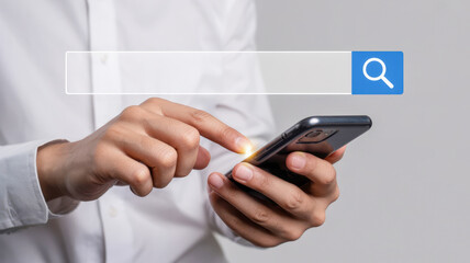 A person's hands holding a smartphone and using a search bar interface on the screen, representing online searching and digital interaction.