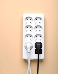 White surge protector with two plugged cables