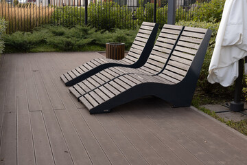 a pair of sun loungers in the garden, a private area for relaxation and sunbathing in a modern...
