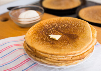 stack of appetizing flour pancakes in the kitchen during cooking
