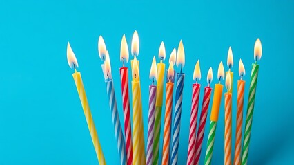 A festive arrangement of colorful birthday candles with glowing flames, creating a cheerful atmosphere.