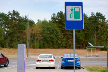 Electric vehicle charging station with parked cars