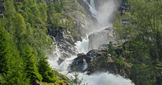Latefossen Waterfall Close-Up With Mist And Evergreen Forest, Norway