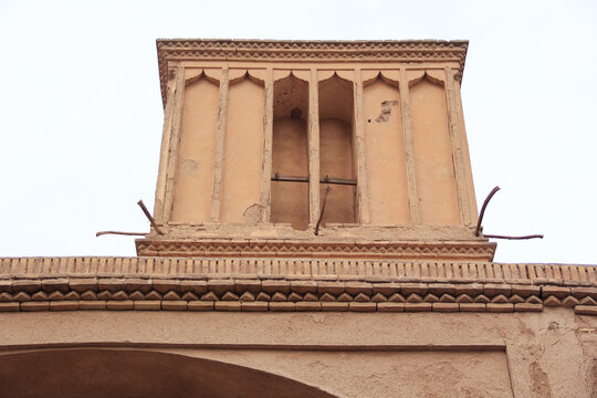 Historic windcatcher and adobe house in Yazd, Iran, showcasing traditional Persian desert architecture and cultural heritage.