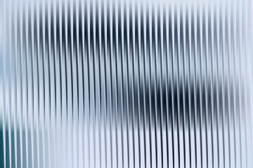 Fototapeta premium Abstract vertical lines create a blurred and textured background in blue tones