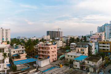 Elevated view of a dense residential area in India, showcasing a mix of building styles and vibrant...