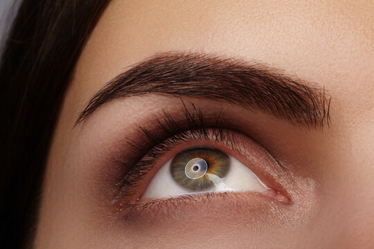 Fototapeta Exquisite closeup photo of a womans eye meticulously showcasing detailed makeup along with vibrant colors. Macro concept perfect for Beauty Salon, Ophthalmological Clinic, Make-up Artist