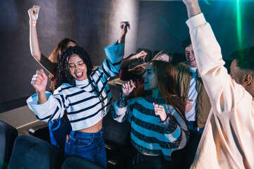 Excited fans dancing and singing along to their favorite band, creating a vibrant and energetic...