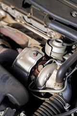Close-up of car turbocharger system showing engine detail, metal texture, and automotive technology concept