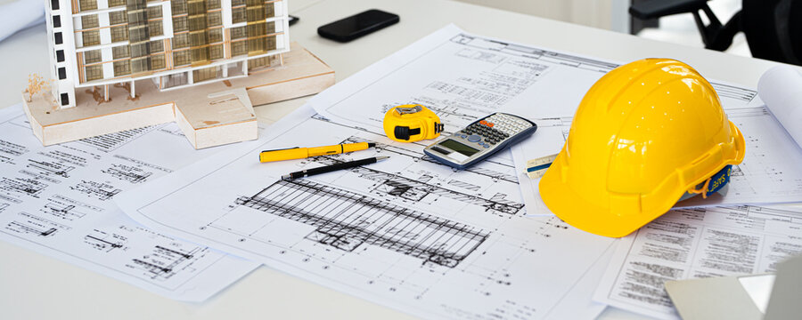 Architect or engineer professional. blueprint , structual  floor plans   with  a pencil,  triangular scale , Shop drawing ,  calculator,  laptop and engineering tools.