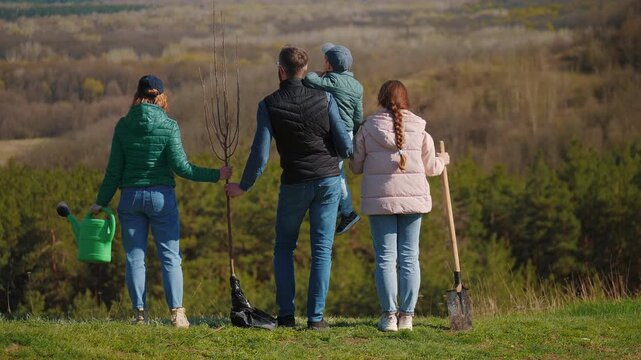 Family planting tree outdoors eco lifestyle concept