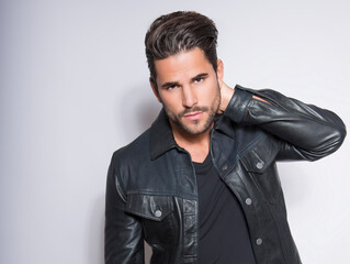 Obraz premium Handsome young man with dark hair and beard posing in casual clothes