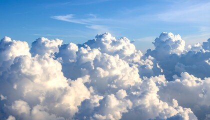 High-altitude view of puffy white clouds against a bright blue sky