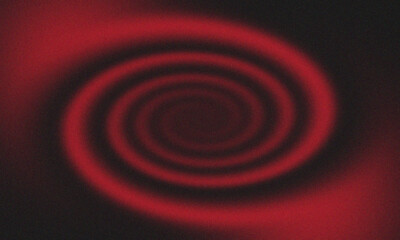 A blurry red spiral pattern against a dark background creating a hypnotic and abstract design effect