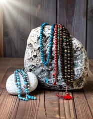 Colorful beaded prayer or meditation bracelets displayed on rocks