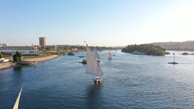 Aerial shot of the Nile River with sailboats in Aswan, Egypt