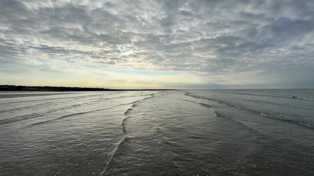 Golden Hour Waves Gently Lapping The Shore At Margate Beach, UK, With A Slow Panning Movement