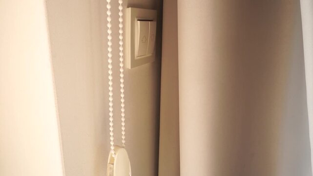 Detail of a roller blind's pull chain