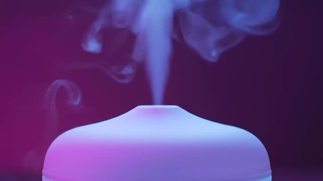 Aromatherapy essential oil diffuser creating a serene and tranquil ambiance with glowing purple light