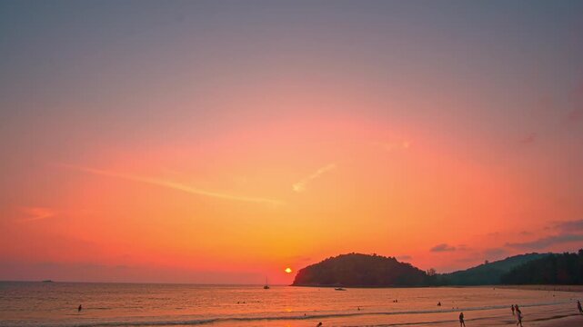 Time lapse A peaceful tropical comes alive with color as the sun sets, offering a perfect moment of serenity and beauty. Vibrant Colors of a Tropical Evening at Kala island Layan beach Phuket