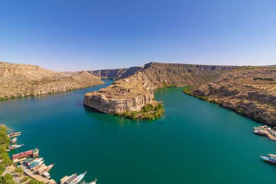 Wide angle view of Rumkale with tour boats on the Euphrates River