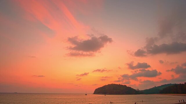 Time lapse A peaceful tropical comes alive with color as the sun sets, offering a perfect moment of serenity and beauty. Vibrant Colors of a Tropical Evening at Kala island Layan beach Phuket